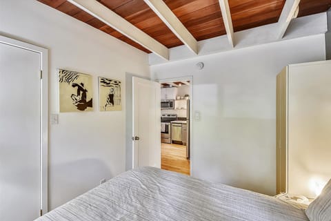 The first bedroom off the kitchen is next to the bathroom.