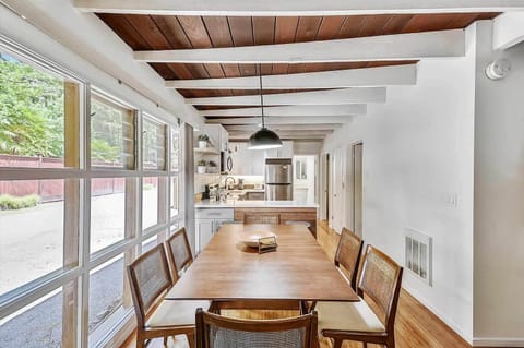 A wall of windows for bright daylight in the dining area.