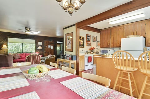 An open dining area with bar seating at the kitchen counter.