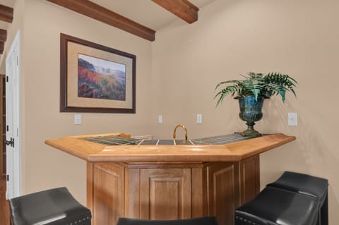 The bar has 4 seats and a mini fridge for the bar keep in your party.