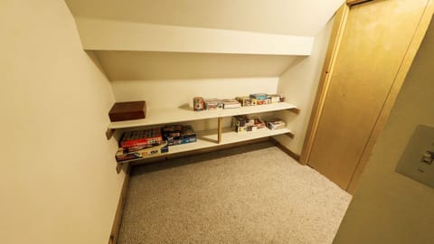 Upstairs: At the top of the stairs is a game shelf