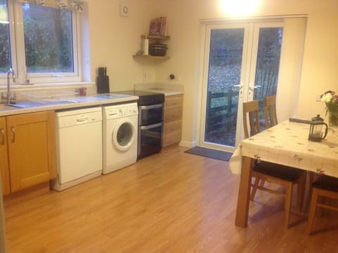 Spacious kitchen, dishwasher, microwave, washing machine with doors to garden