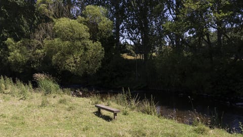 Old Mill Cottage - a bench beside the river