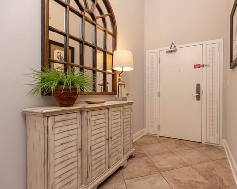 This welcoming entryway features a stylish console table, a decorative mirror, and a soft lamp, perfect for a warm arrival