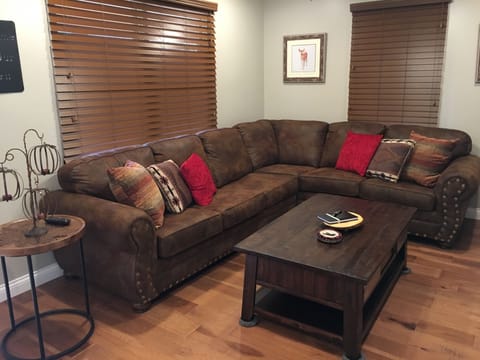 Living room area with sectional sleeper sofa. 55 inch flat screen with DISH