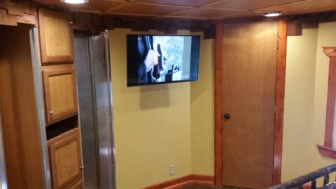 A flat screen television in the Queen sized mattress bedroom