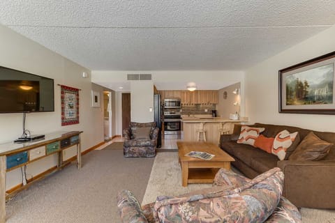The spacious living room includes a large flatscreen TV with Blu Ray player.