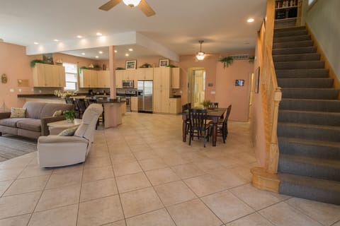 Main Level | Living Room - Walk into this massive beach home with a feel of the coast. Open floor plan perfect for your large group gatherings. A holiday favorite.