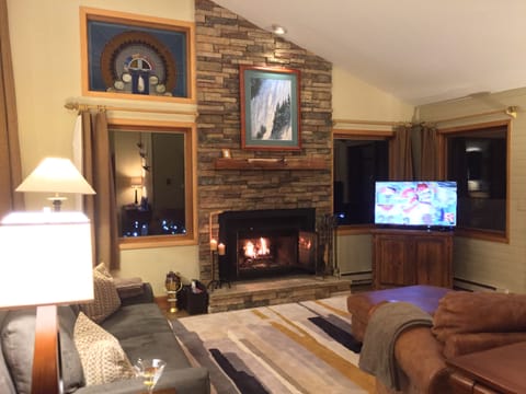 Family room with cozy, wood burning fireplace and TV w/cable service.
