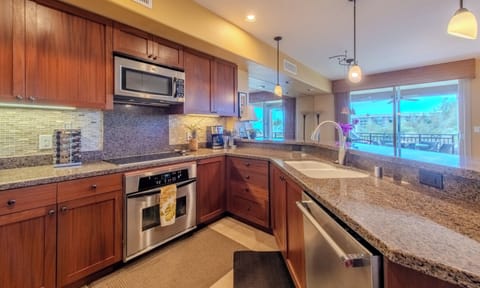 Well-stocked gourmet kitchen with stainless appliances.