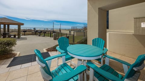 Outdoor ground floor patio with vibrant furniture and direct access to the beach and pool area