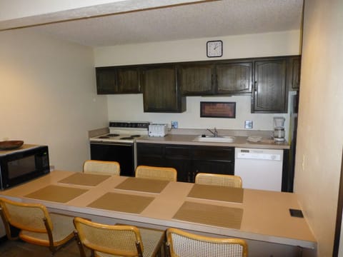 Ample seating for 6, very dated cabinets, counters, appliances, newer dishwasher