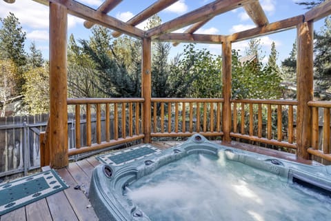 Private outdoor hot tub, surrounded by tall pines, perfect for relaxing under the trees after a day of adventure—enjoy peaceful forest views, fresh air, and a truly rejuvenating stay.