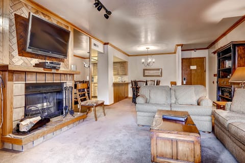 Warm open living dining cozy wood burning fireplace large screen TV - Park City Lodging-Park Station-232-1-Living Room