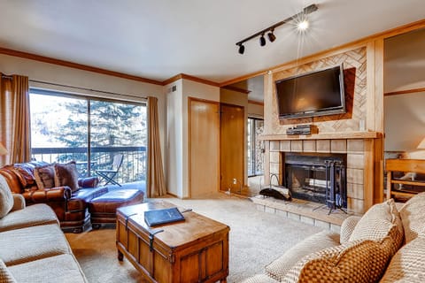 Cozy wood burning fireplace large screen TV private balcony - Park City Lodging-Park Station-232-1-Living Room
