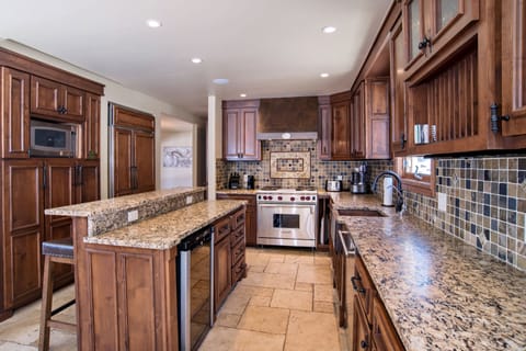 Kitchen with stainless steel appliances and stone countertops