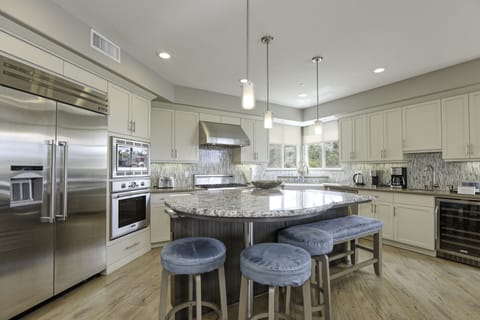 Expansive granite counter space engulf the kitchen island. Plenty of room to prep dinner while uncorking a local cab.