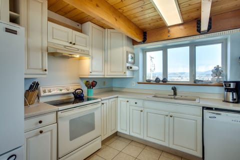 Open and bright kitchen is fully stocked with amenities.