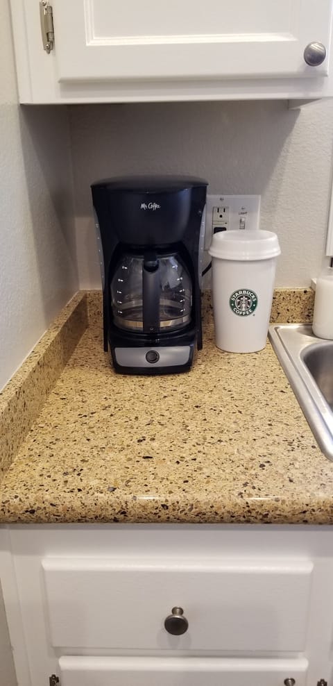 Starbucks coffee is provided. Cups, creamers in the cabinet above + FIRSTAID kit