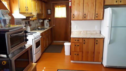 Renovated kitchen with a  new stove and fridge...a clean and spacious area to create those great meals that always taste better here at the cottage...