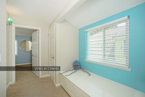 Relaxing hallway window seat.  Extra blankets and pillows in the cabinets.
