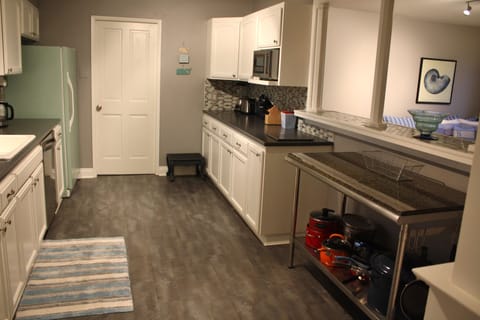 Kitchen view from other end, bar & great room on right. Tons of counter space!