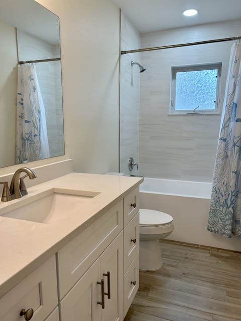 Full size bathroom with tub and shower
