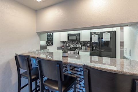 3 seat bar between kitchen and dining area perfect for laptops and doing work!