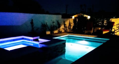 Nighttime in the garden pool with remote controlled LED lights. 