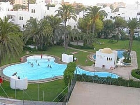 Complex pools & green sunbathing area.