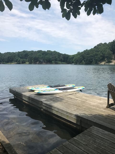 2 paddle boards with paddles on our large floating dock