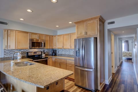 Modern kitchen with all stainless steel appliances and granite countertops 