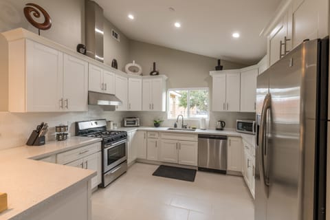 Contemporary kitchen with soft-close cabinets and stainless steel appliances.