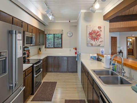Full kitchen with views of the water and open living area.