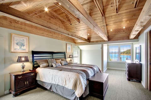 The large and spacious bedroom is furnished with a king sized bed and has a flat screen TV