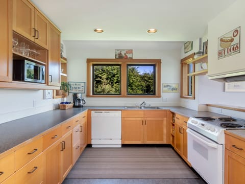 Fully stocked kitchen with coffee pot (coffee not provided), microwave, dishwasher and oven.
