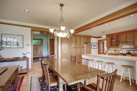 The dining room is open to the kitchen for easy serving and opens to the deck via french doors