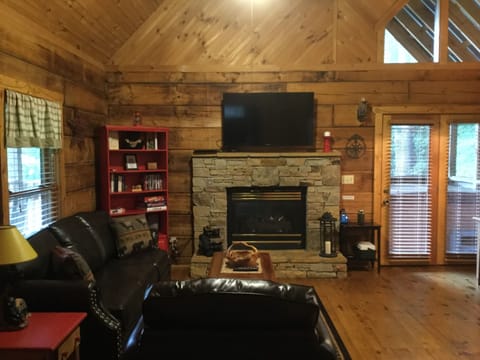 Flat screen TV and cozy gas fireplace that can also be seen from the bedroom!