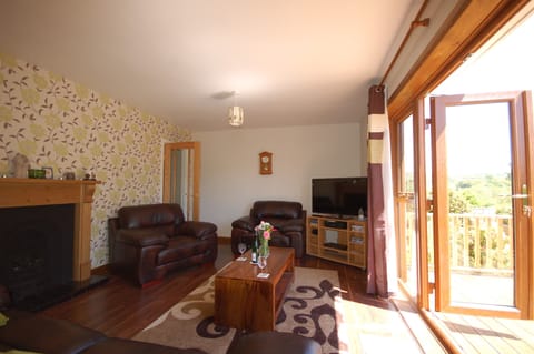 beautiful sitting room leading to large decked area and garden.
