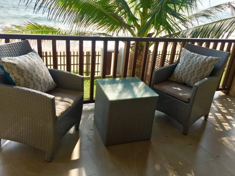 Comfortable chairs, cushions and table for enjoying the sea view and breeze