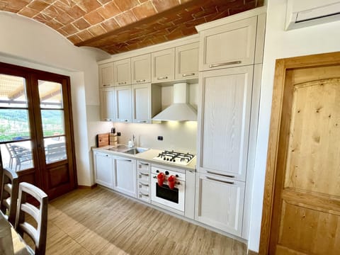 New kitchen leading out to covered outdoor dining.