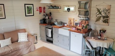 Lounge and Kitchen Area at Cuttermoon Lodge. The lounge has a double sofa bed 