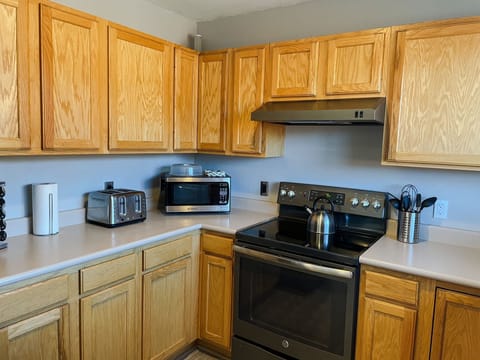 The kitchen also has smaller appliances like a microwave, toaster, and crockpot.