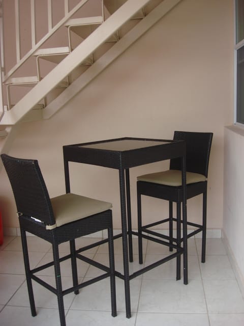 Private balcony with bar height table seating for two.