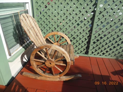 Wagon wheel chair on deck in front of the apartment.