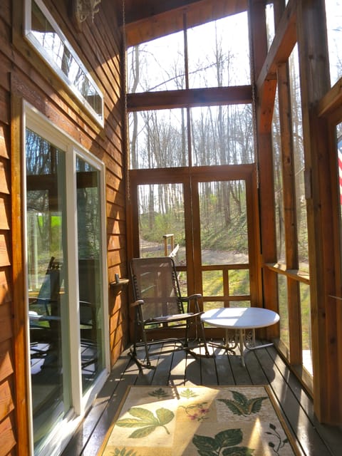 The screen porch is a great place to slip away with a coffee in the morning.