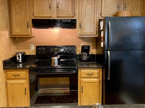 Fully Equipped Kitchen Has Coffee Maker, Toaster, Dishes and Cookware