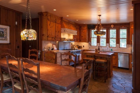 The dining room and kitchen, featuring a true commercial stove
