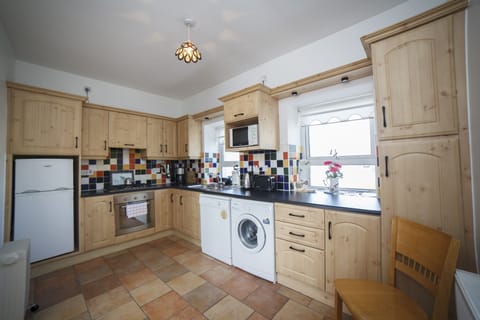 Bright, well equipped kitchen has everything you need for home cooking