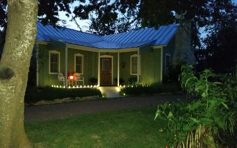 Cottage at dusk late Sept. 2017 - porch lights are under antique blue insulators